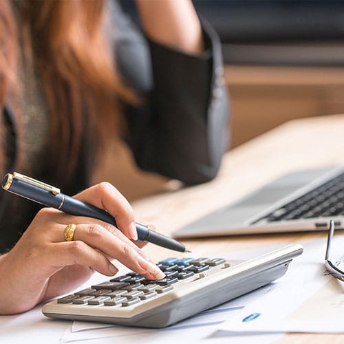 Tax Smart Advisors LLC, Tax & Accounting Firm Serving the Lehigh Valley | Photo: Person sitting at desk using calculator